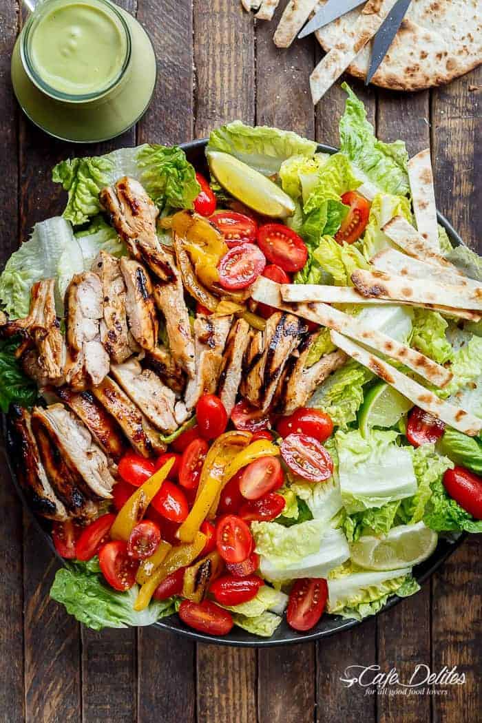 Tequila Lime Chicken Taco Salad with an Avocado Crema spiked with honey, lime and booze. Complete with tortilla strips, have a chicken taco in a salad! | https://cafedelites.com