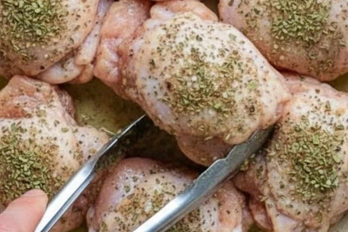 Coat the chicken thighs with oregano, basil, salt, and pepper,
