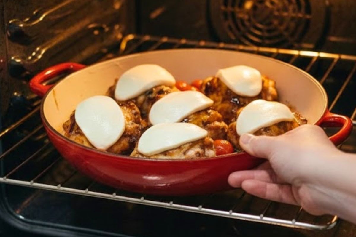 Place a slice of mozzarella on each thigh and return the pan to the oven until the cheese melts 