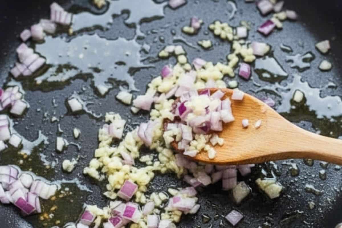 Add the remaining olive oil to the same pan and cook the garlic and onion.