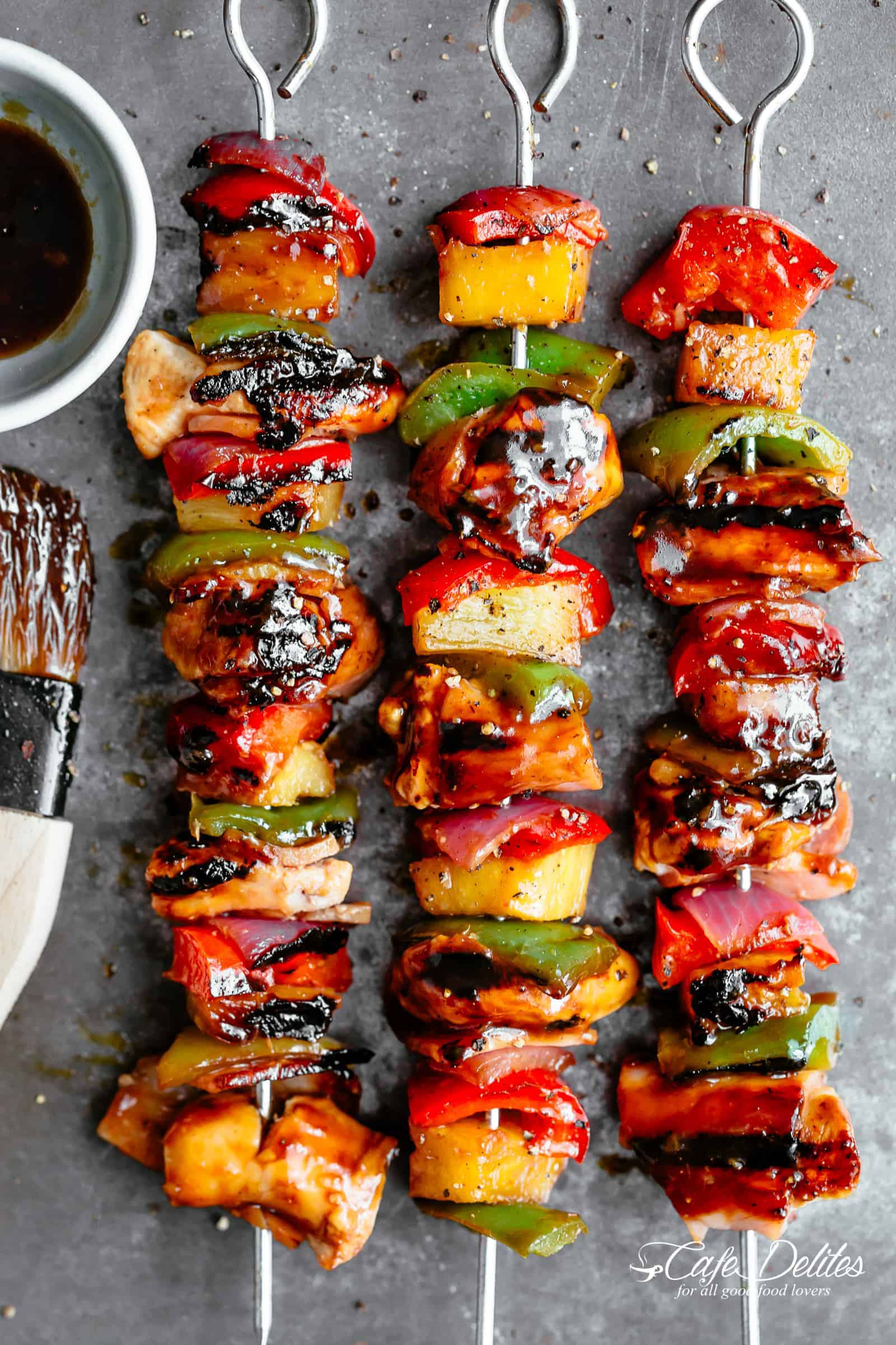 Hawaiian Bacon Pineapple Chicken Kebabs with a BBQ twist! Crispy bacon and chicken smothered in a Hawaiian style pineapple and barbecue sauce, these skewers are so addictive! | https://cafedelites.com
