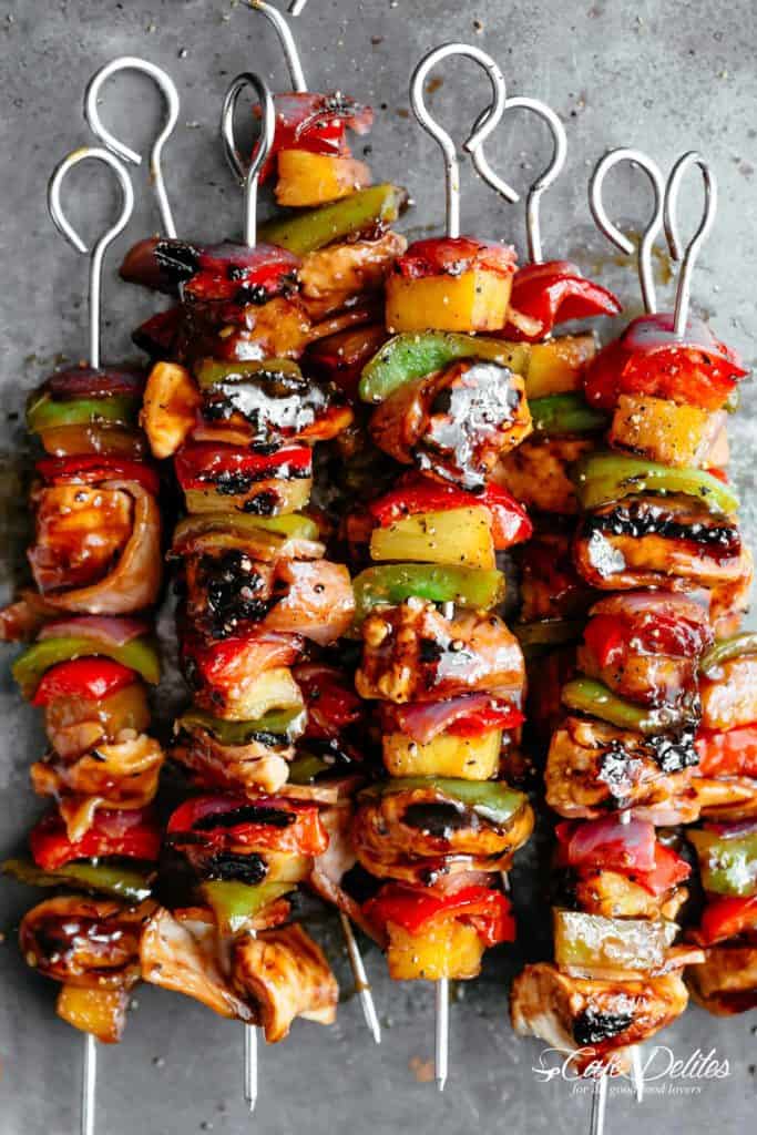 Hawaiian Bacon Pineapple Chicken Kebabs with a BBQ twist! Crispy bacon and chicken smothered in a Hawaiian style pineapple and barbecue sauce, these skewers are so addictive! | https://cafedelites.com