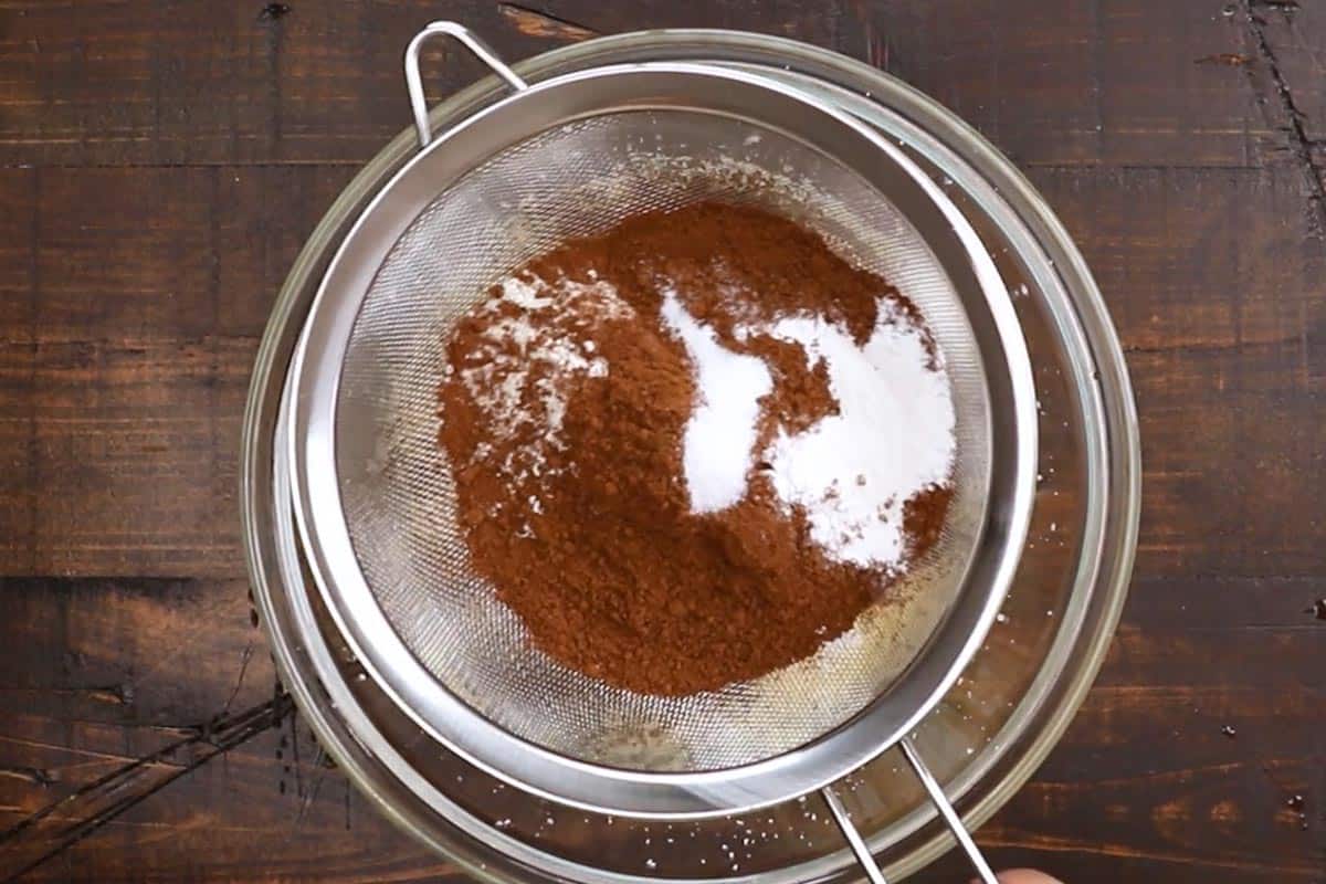 Sifting in the flour, cocoa powder, baking powder, and salt. - 5