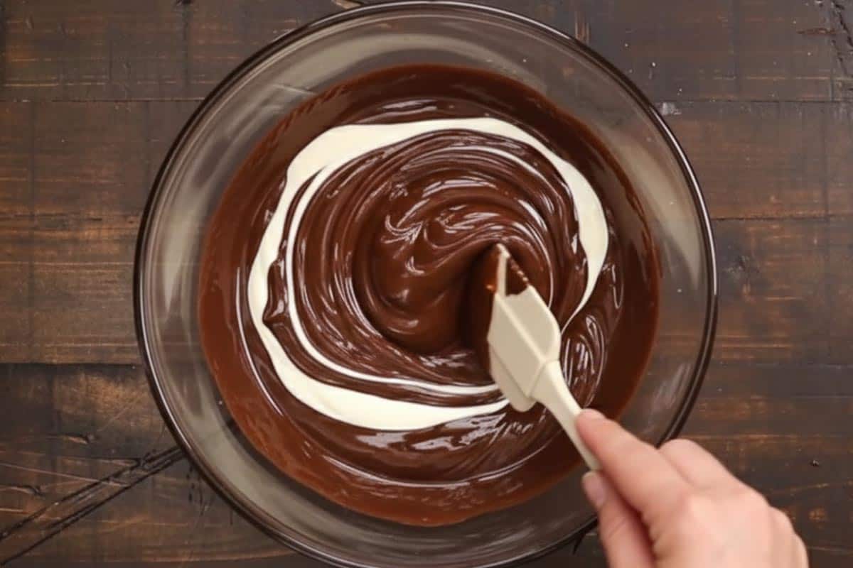 Stirring yogurt in a bowl of melted chocolate. - 9