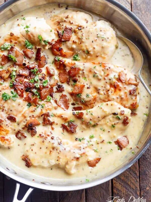 A deliciously Creamy Honey Mustard Chicken with crispy bacon pieces in a pan