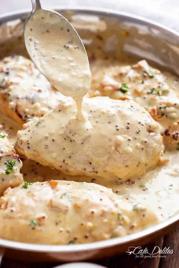 Creamy Honey Mustard dressing pouring on a Chicken with crispy bacon pieces 