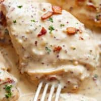 Fork pierced into a Creamy Beer Cheese Chicken