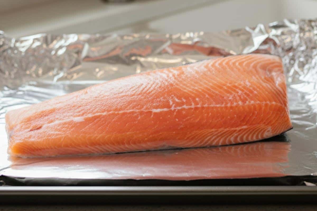 Placed the salmon fillet skin-side down on the prepared foil-lined tray.