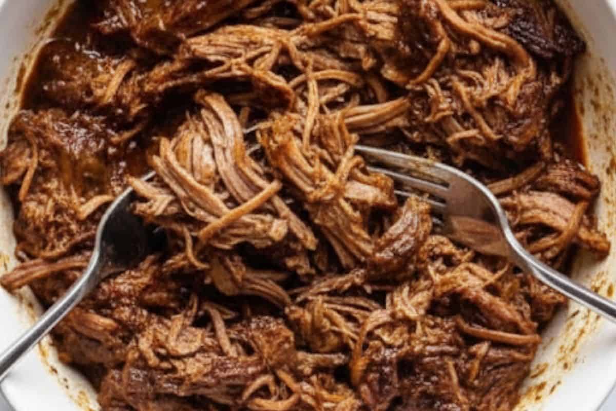 Remove the ribs from the sauce, discard the bones, and shred the meat with two forks