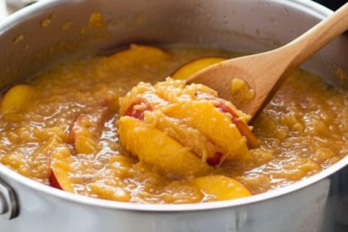 After steeping, use a whisk or wooden spoon to mash the softened peaches until they break down completely.