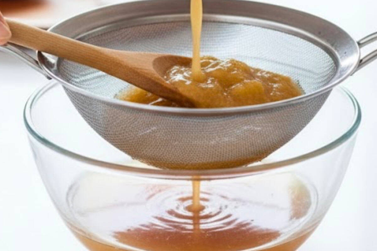 Place a bowl under a fine mesh strainer and pour in the peach mixture. Press the fruit with the back of a spoon to extract as much liquid as possible.