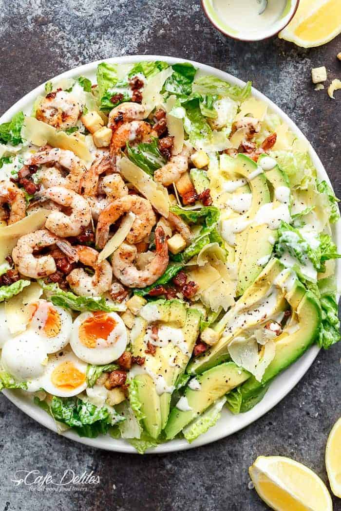 Grilled and Skinny Lemon Garlic Shrimp Caesar Salad with a lightened up creamy Caesar dressing is a complete meal in a salad and a family favourite! | https://cafedelites.com