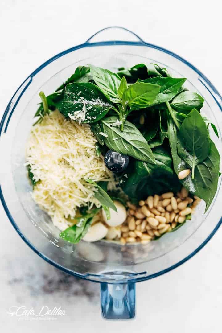 Fresh Basil, parmesan, pine nuts, garlic in a jug ready to be blended. 