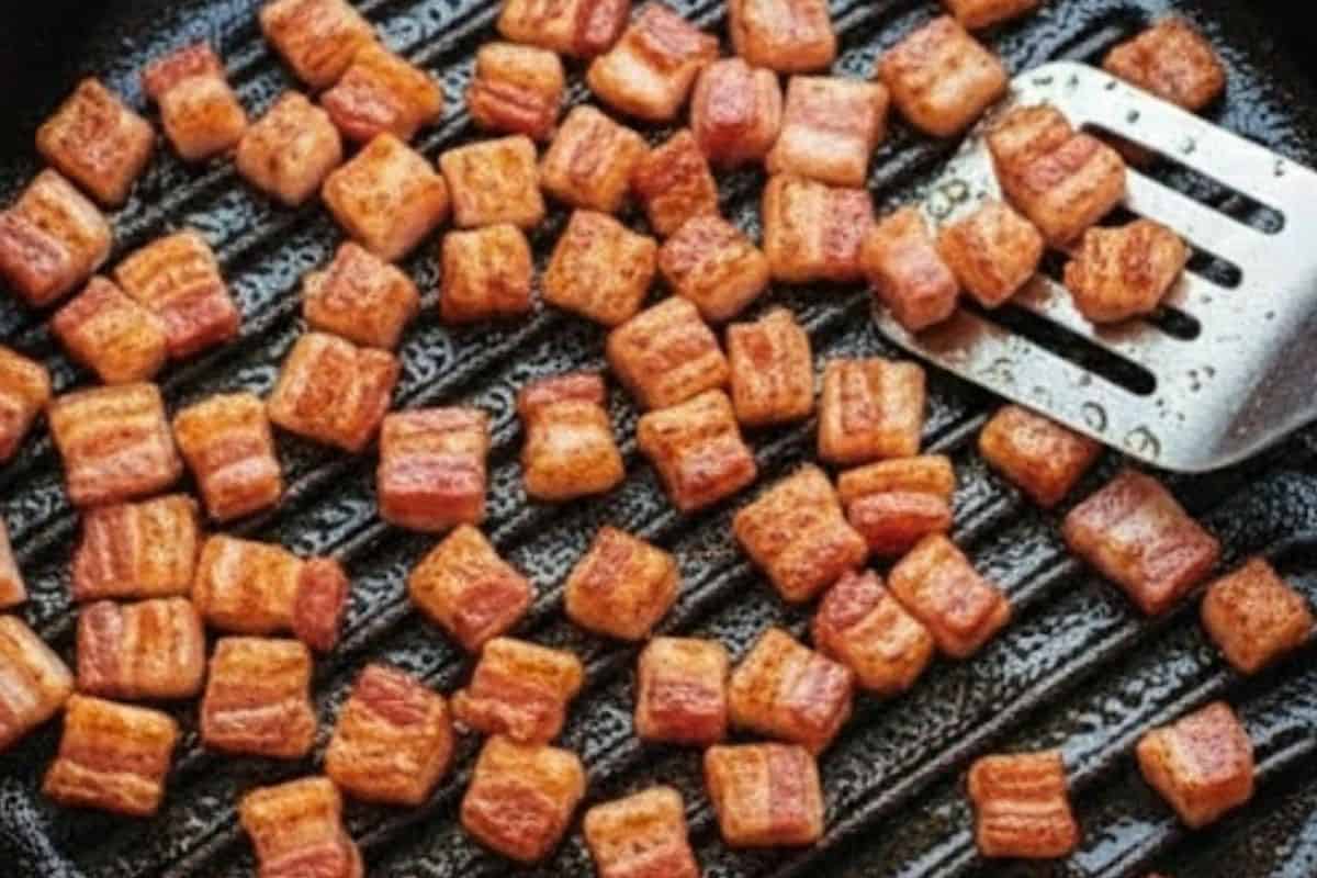 In a skillet over medium-high heat, fry the bacon until golden and crispy.