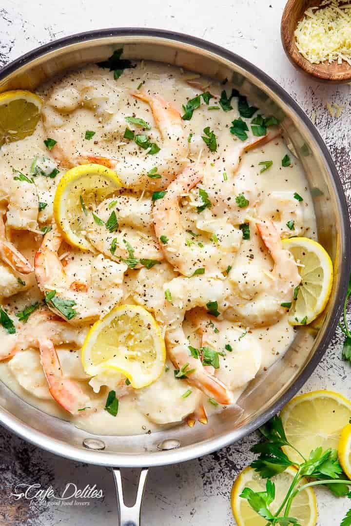 Creamy Lemon Parmesan Shrimp is a restaurant quality gourmet meal! Only minutes to make and full of lemon parmesan flavours with a good kick of garlic and NO HEAVY CREAMS as an option! Plus no dairy options! | https://cafedelites.com