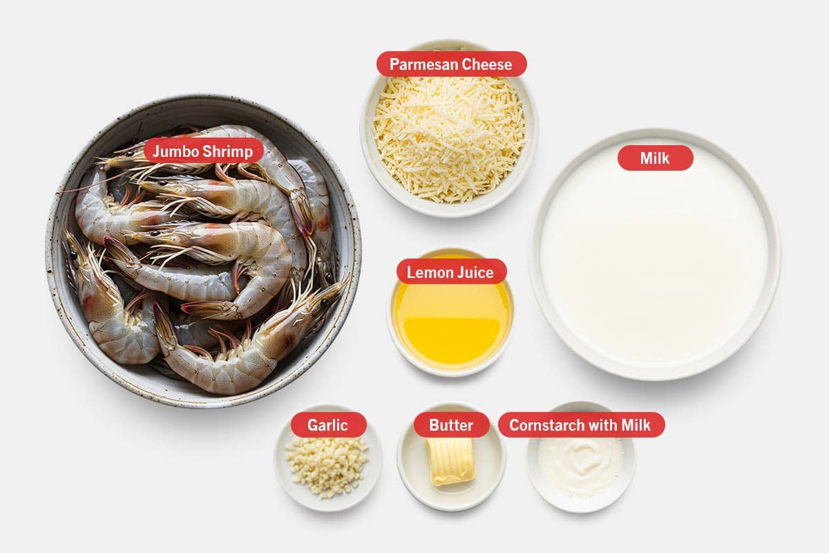 Top shot of ingredients: Jumbo shrimp, parmesan cheese, lemon juice, milk, garlic, butter, and cornstarch with milk.