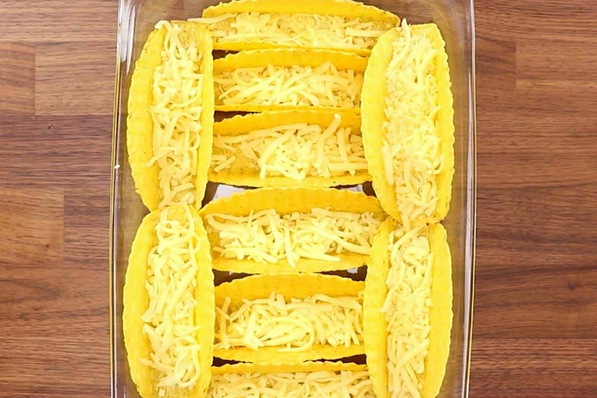 Arranged the taco shells in the dish and added cheese. - 7