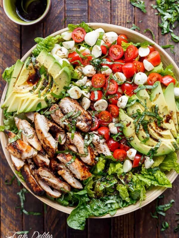 Balsamic Chicken Avocado Caprese Salad is a quick and easy meal in a salad drizzled with a balsamic dressing in a plater