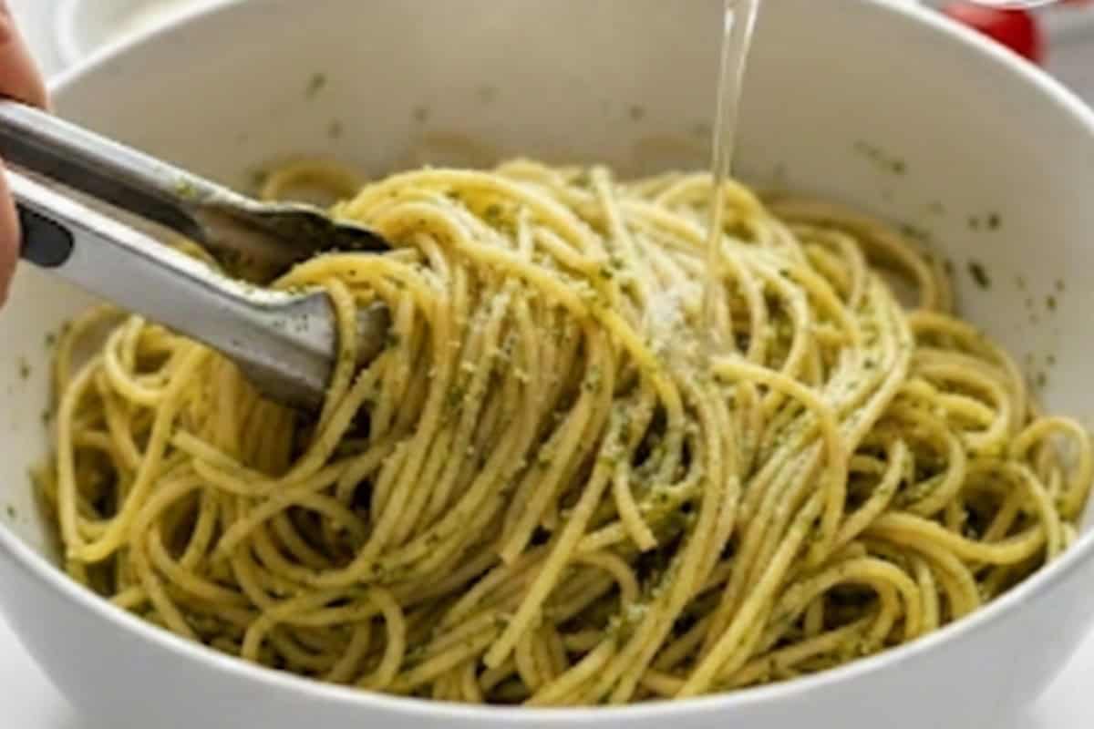 Add the remaining pesto to the cooked spaghetti with the 1/2 cup reserved pasta water. Toss until fully combined.