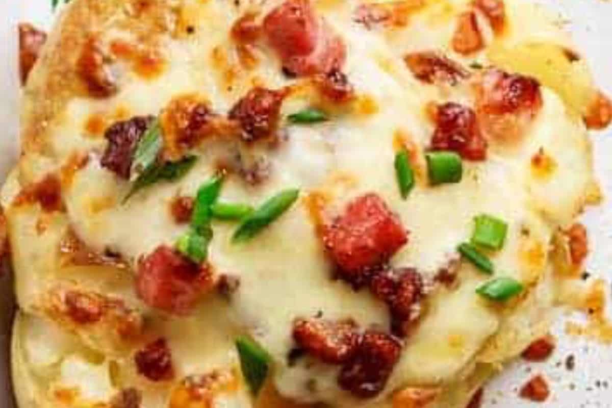 Top the hot potatoes with mozzarella and crisp bacon and return to the oven.