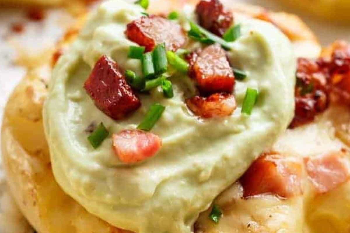 Sprinkle with chives, season lightly with salt, and serve warm with creamy avocado crema.