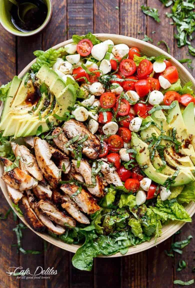 Balsamic Chicken Avocado Caprese Salad is a quick and easy meal in a salad drizzled with a balsamic dressing that doubles as a marinade! | https://cafedelites.com