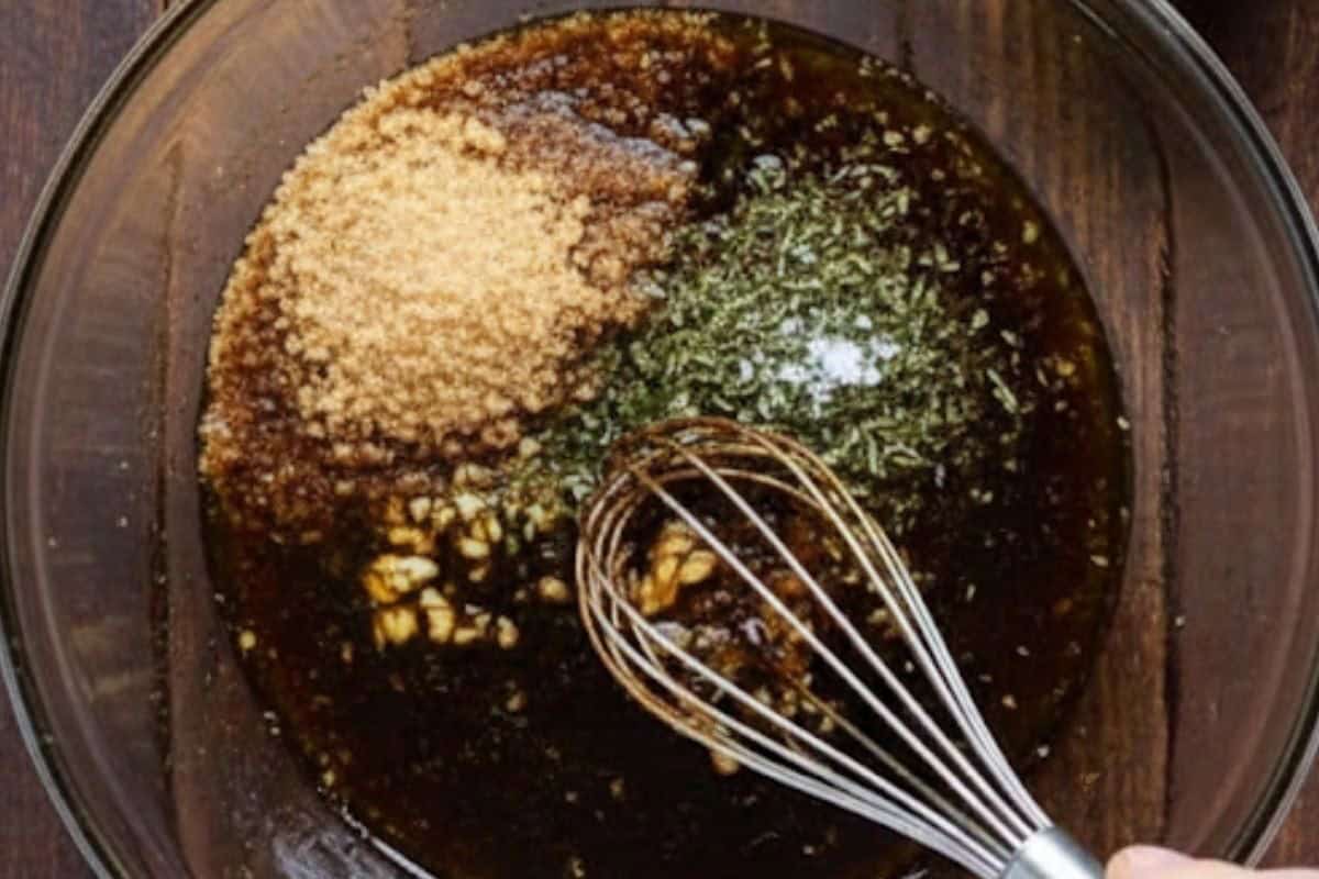 In a bowl, whisk together balsamic vinegar, olive oil, brown sugar, garlic, dried basil and salt.