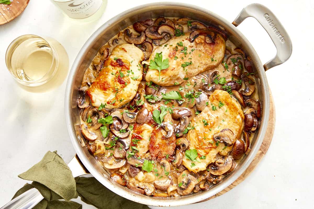 Creamy champagne chicken and mushrooms bubbling gently in the skillet.