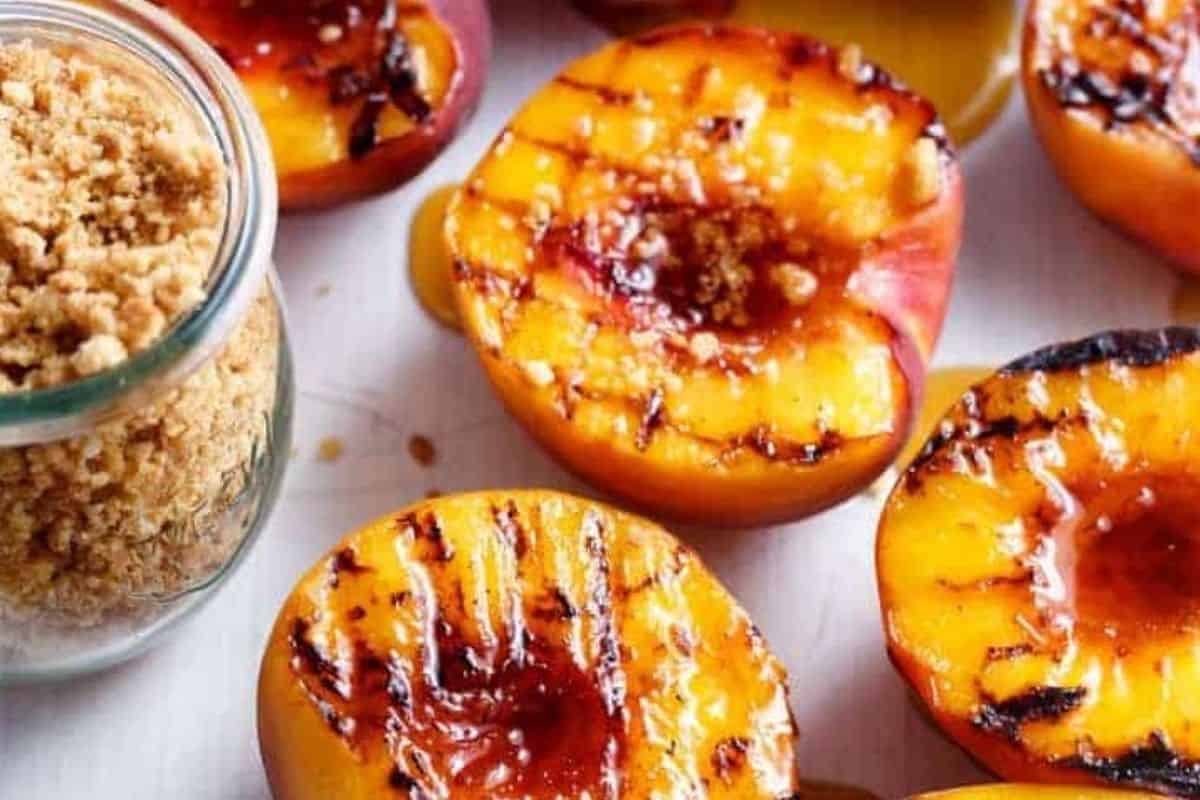 Drizzle the grilled peaches with extra maple syrup, top with a scoop of ice cream, and finish with a generous sprinkle of the almond cookie crumbs. - 8