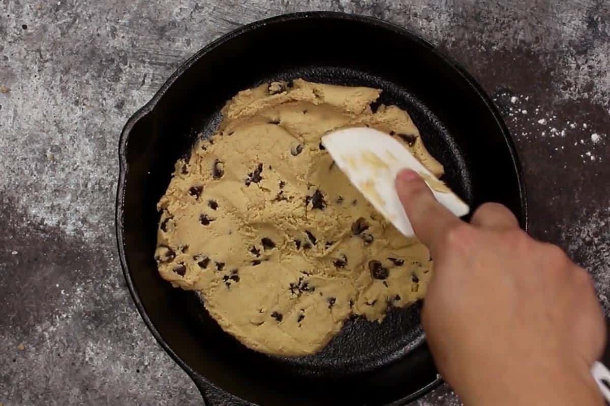 Pressing the cookie dough in a skillet. - 8