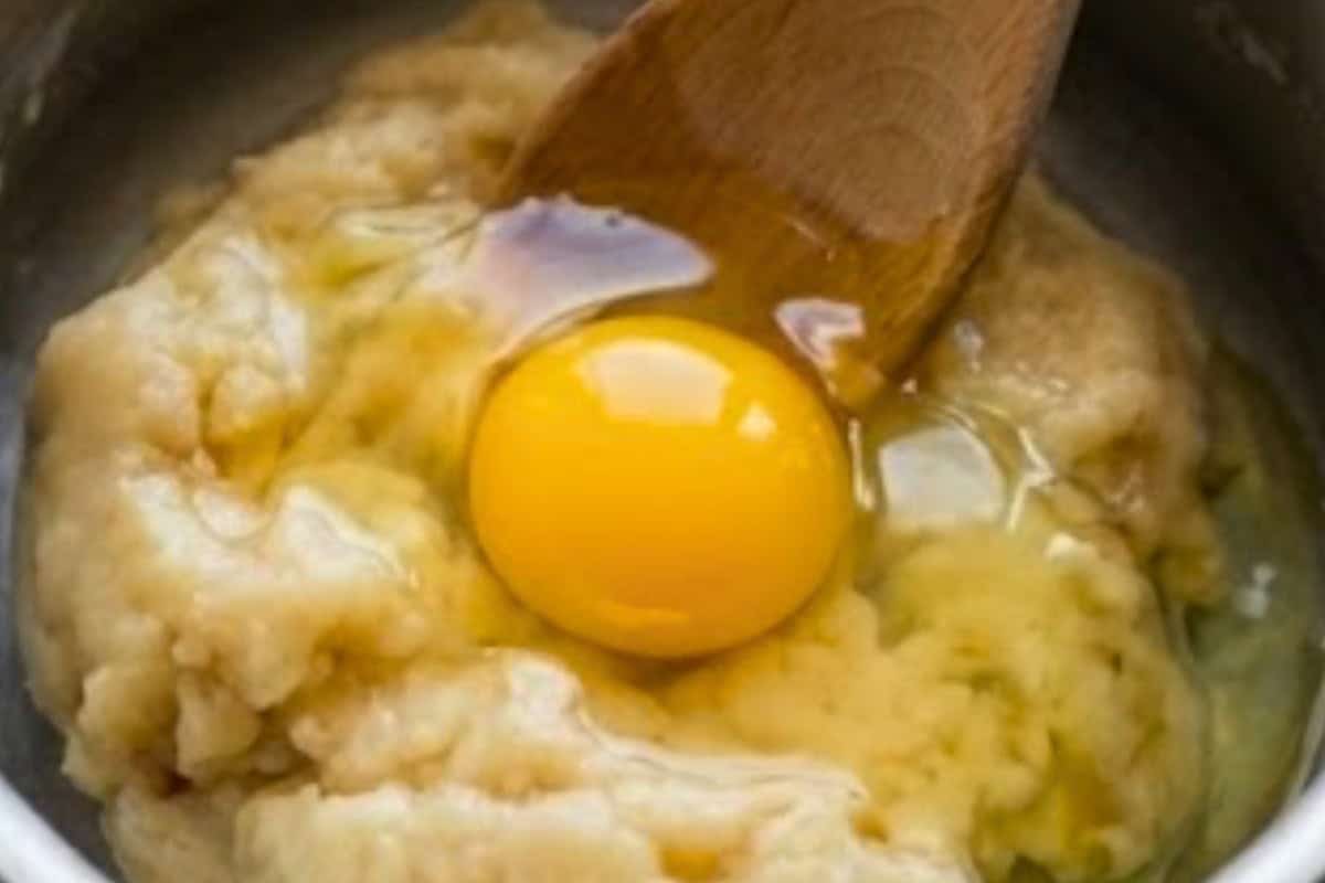 Remove the dough from heat and let it cool for about 5 minutes until warm to the touch. Beat in one egg at a time - 5