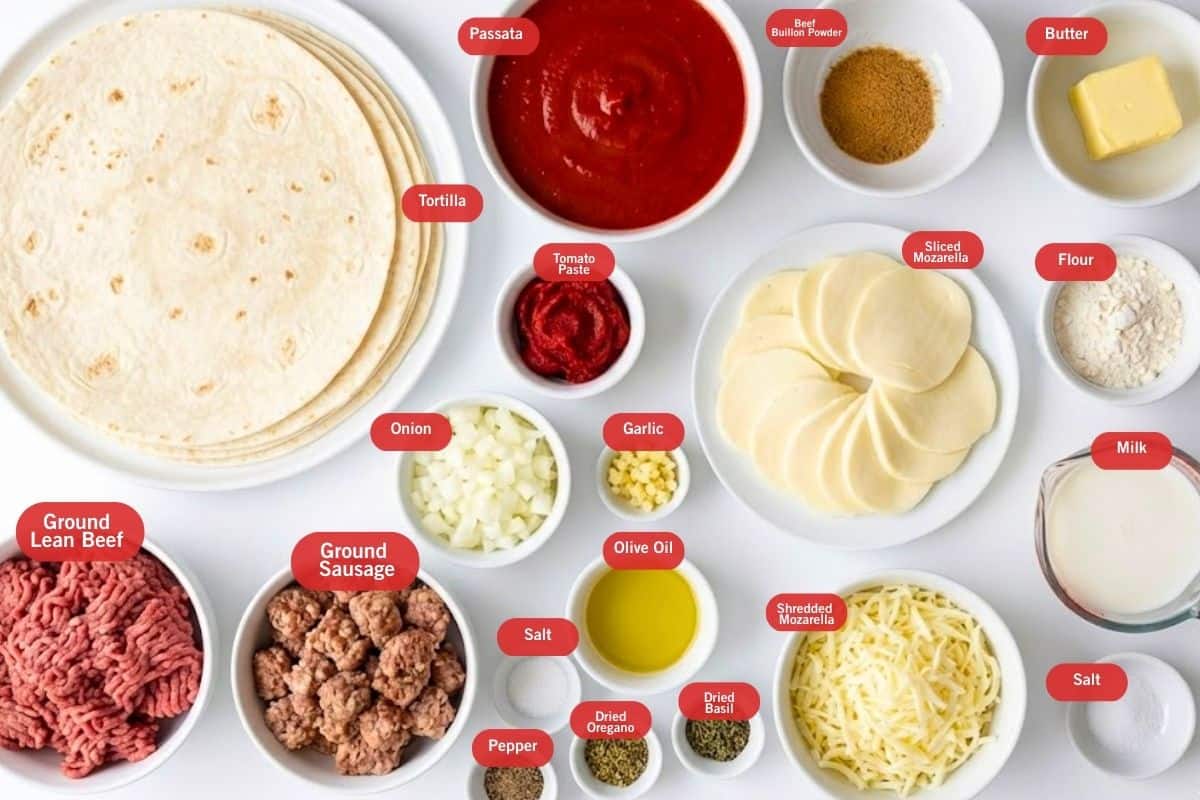 Flat lay photo of ingredient shot of tortillas, passata, beef bouillon powder. butter, flour, milk, salt, shredded mozzarella, sliced mozzarella, tomato paste, onion, garlic, olive oil, dried basil, dried oregano, pepper, salt, ground sausage, ground lean beef - 2