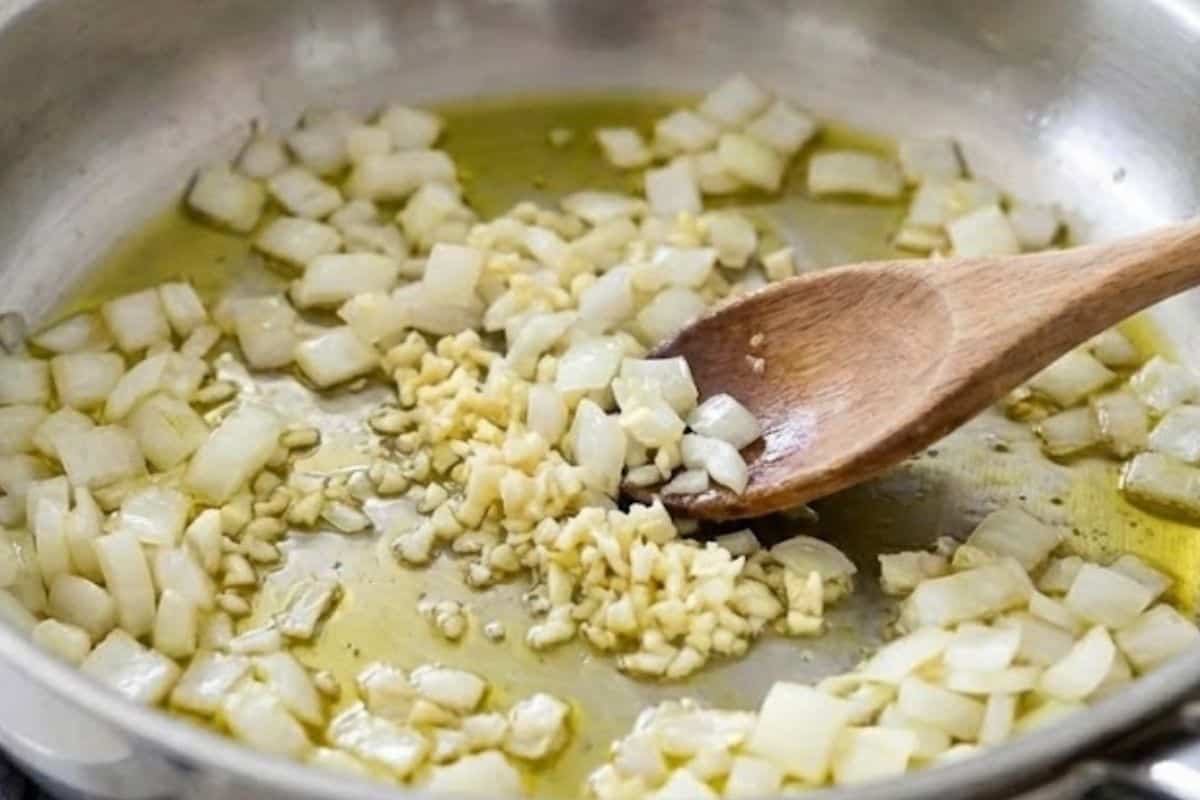 Heat the olive oil in a large pan over low to medium heat, then sauté the onion and garlic - 4