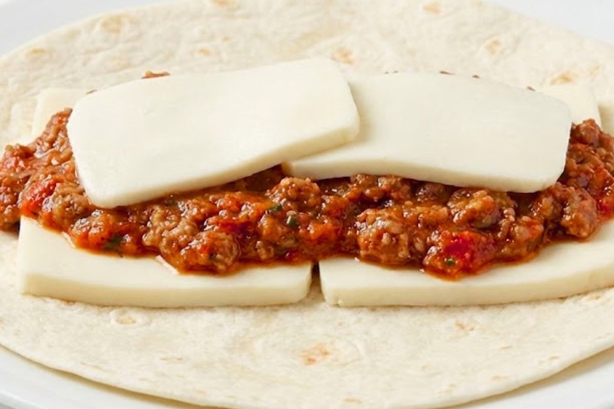 Layer mozzarella, about one quarter cup of meat sauce, and more mozzarella onto each tortilla - 9