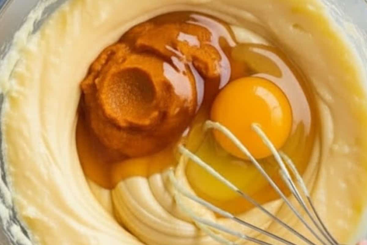 Whisk in the golden syrup, vanilla extract, and egg until fully incorporated and fold in the pumpkin puree.
