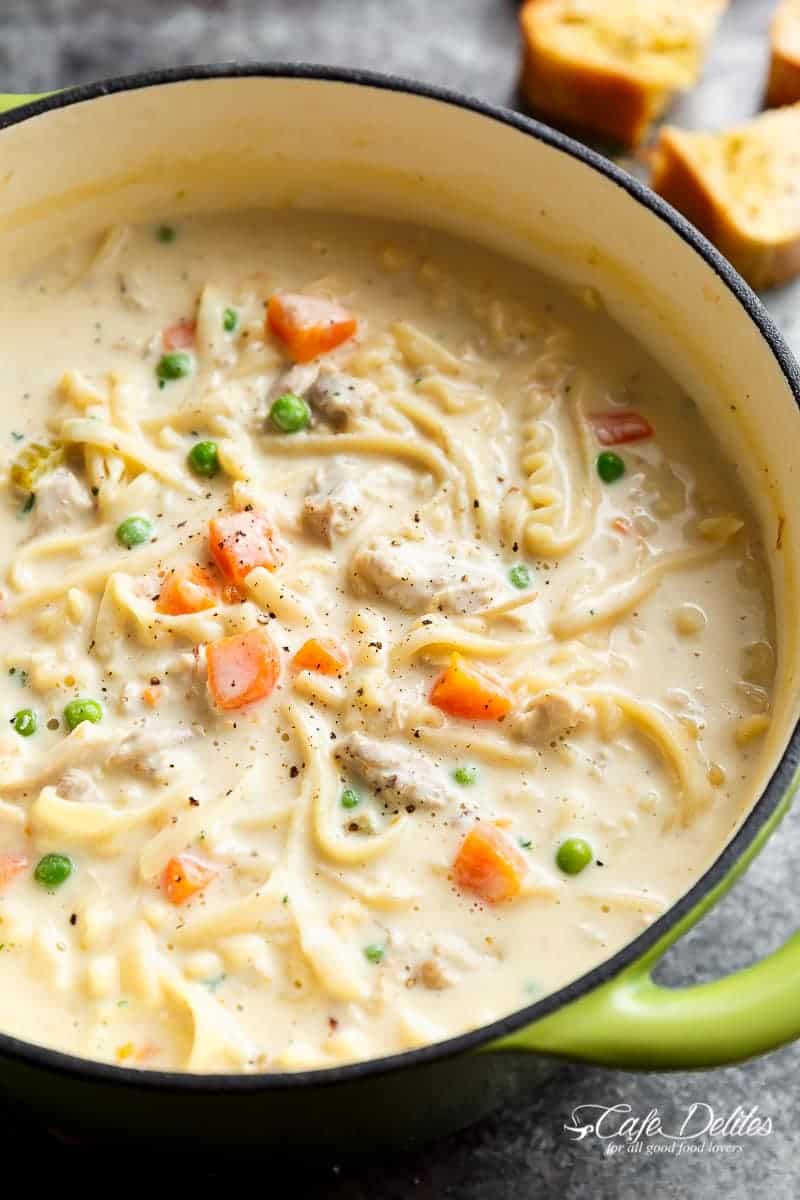 Super creamy Chicken Noodle Soup beats any soup any day. The perfect comfort food in a bowl, lightened up with half of the calories AND no heavy cream! | https://cafedelites.com