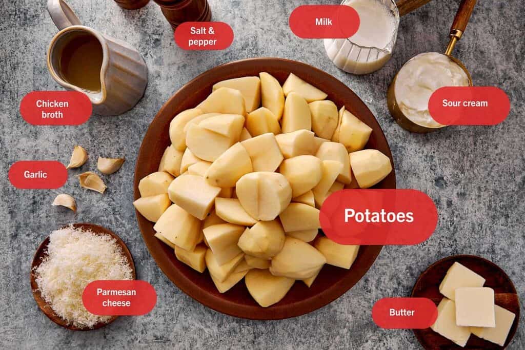 top down shot of all the ingredients to make creamy mashed potatoes on the kitchen top all in individual bowls. - 2