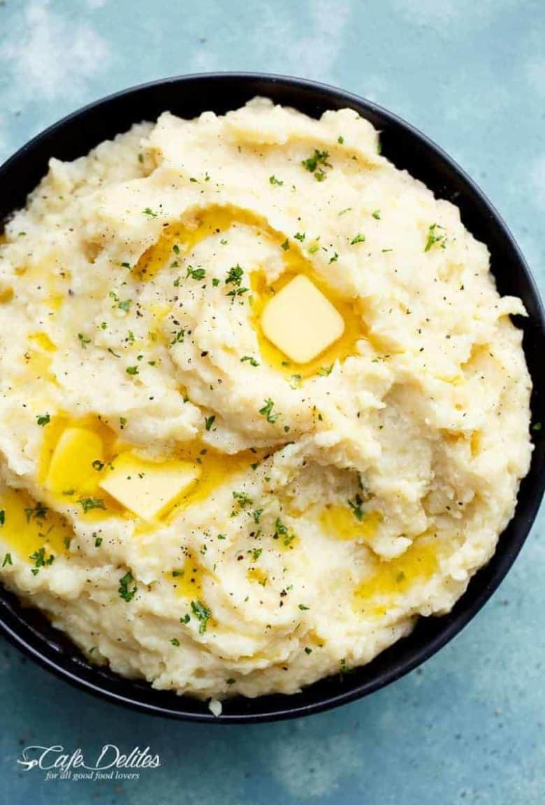Creamy Slow Cooker Mashed Potatoes are incredibly easy to make! With a hint of garlic and parmesan cheese, this will become your favourite recipe! | https://cafedelites.com