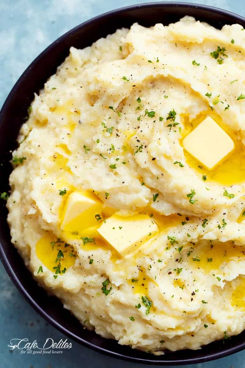 Creamy Slow Cooker Mashed Potatoes are incredibly easy to make! With a hint of garlic and parmesan cheese, this will become your favourite recipe! | https://cafedelites.com