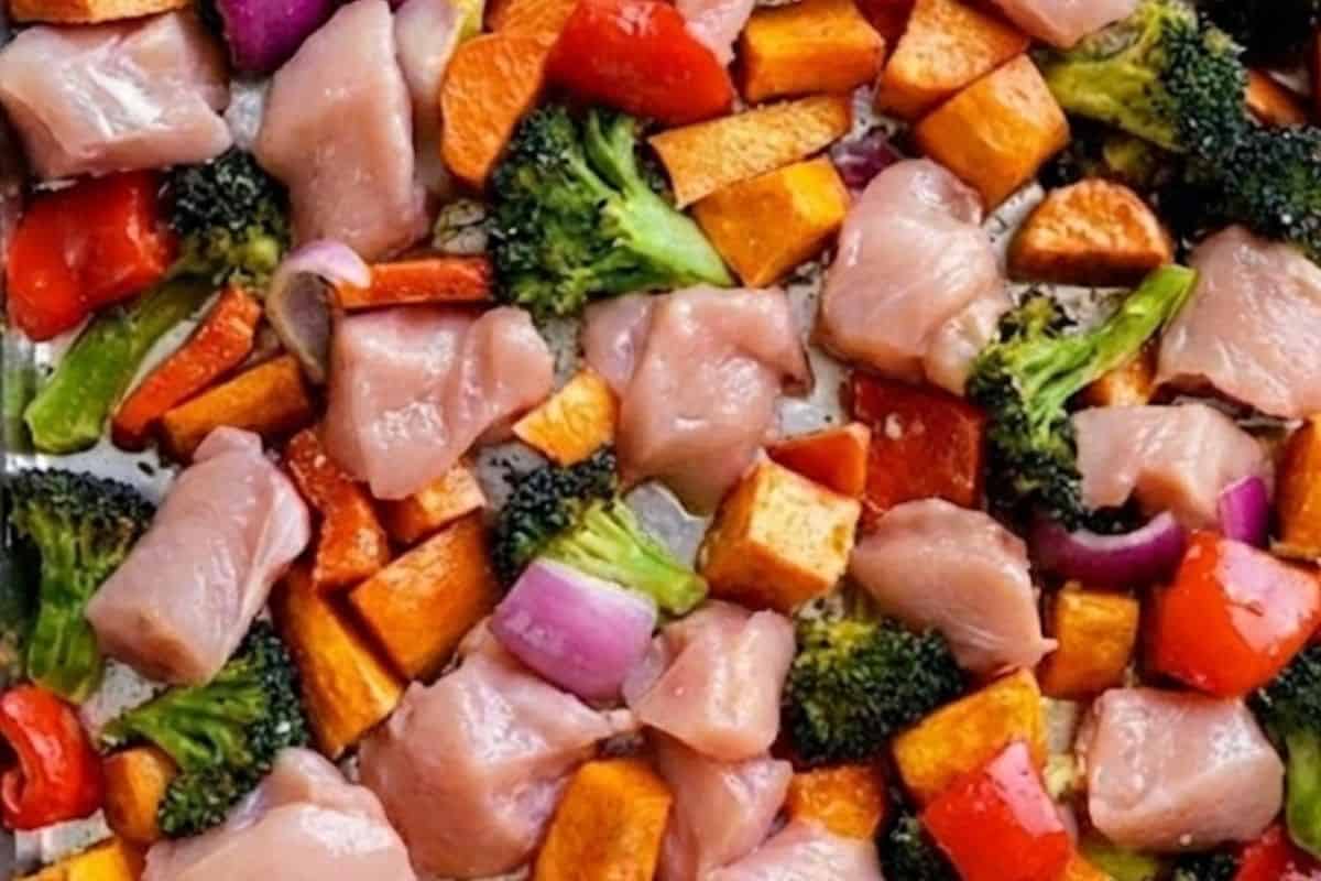 Remove the tray and arrange the chicken, broccoli, pepper, and onion around the sweet potatoes. - 6