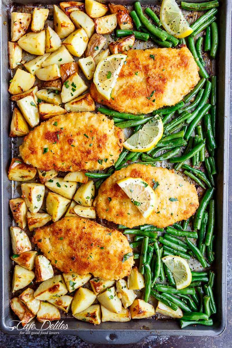 Oven baked and CRISPY breaded Sheet Pan Lemon Parmesan Garlic Chicken & Veggies, complete with potatoes and green beans smothered in a garlic butter sauce! | https://cafedelites.com