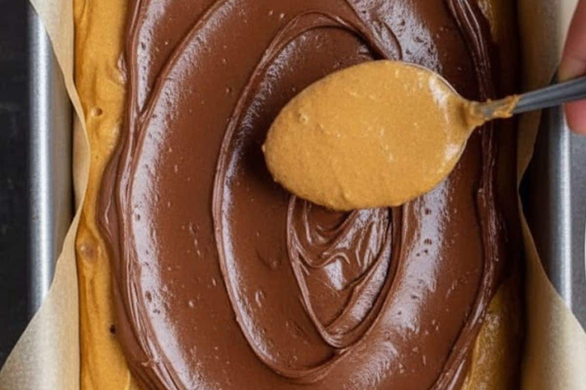  Pour half the batter into the prepared pan. Spread melted Nutella over the top in an even layer