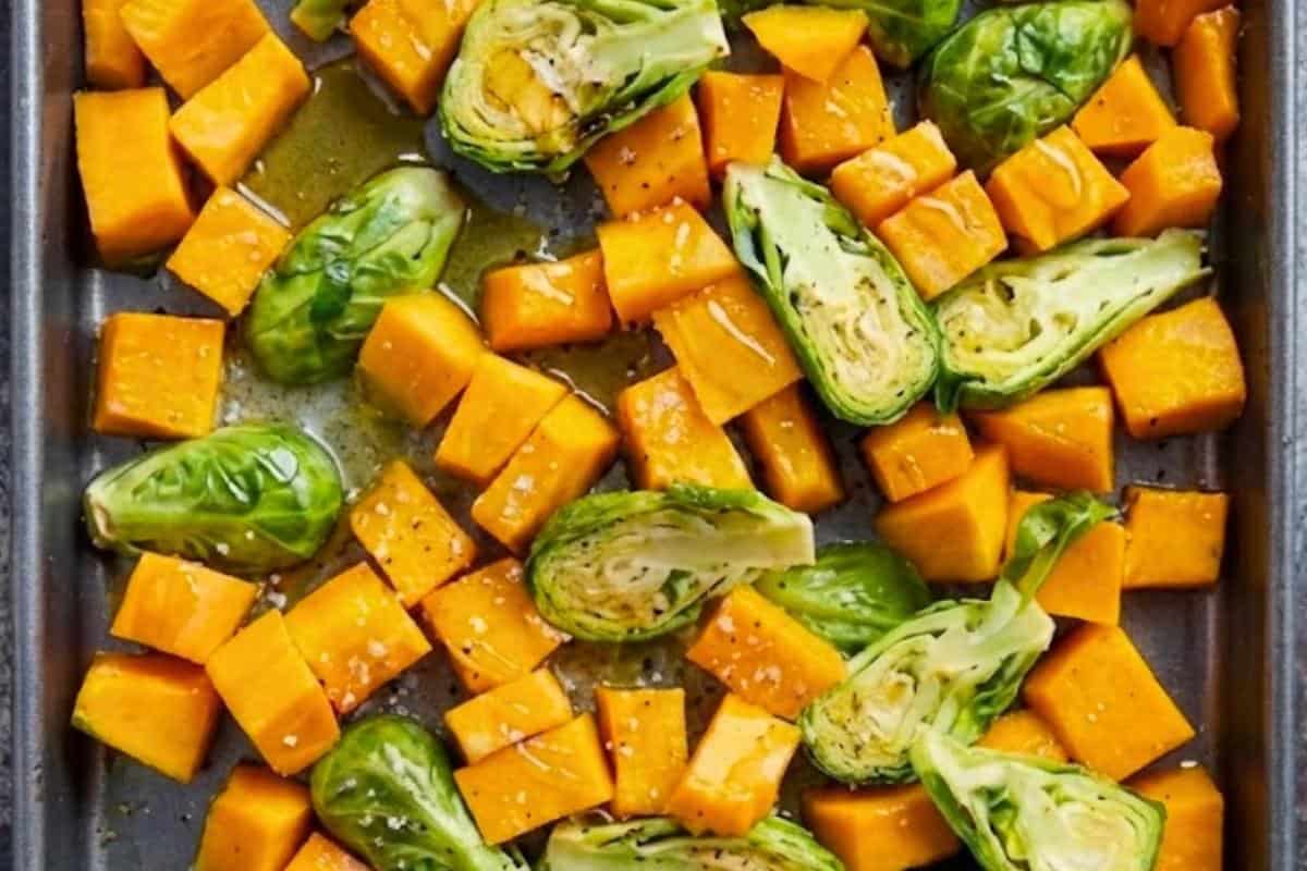 Add the butternut squash and brussels sprouts together on prepared baking sheet. Drizzle with honey and melted butter (or olive oil), season with salt. Toss to evenly coat. - 4
