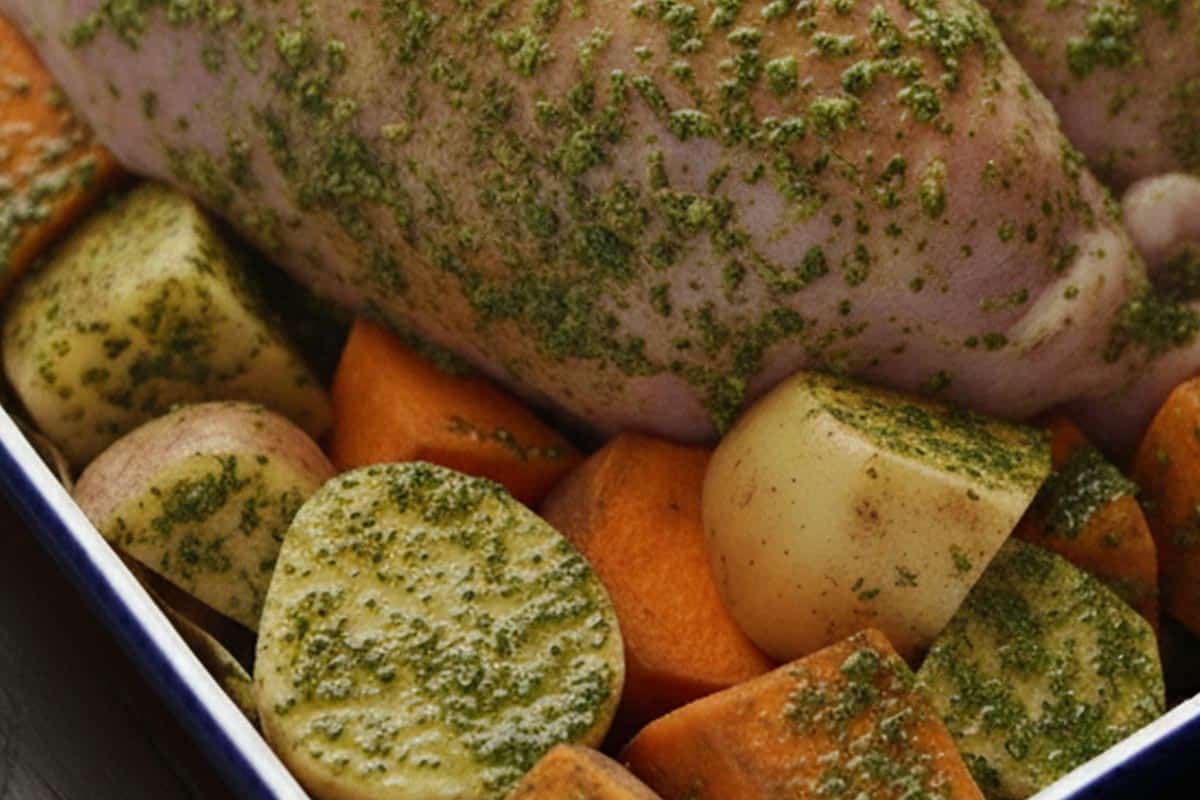 Arranged the sweet potatoes and regular potatoes around the turkey and coat with the herb mixture.