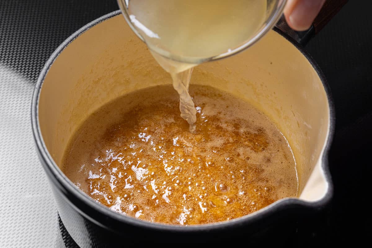 Garlic butter sauce in a pot being heated