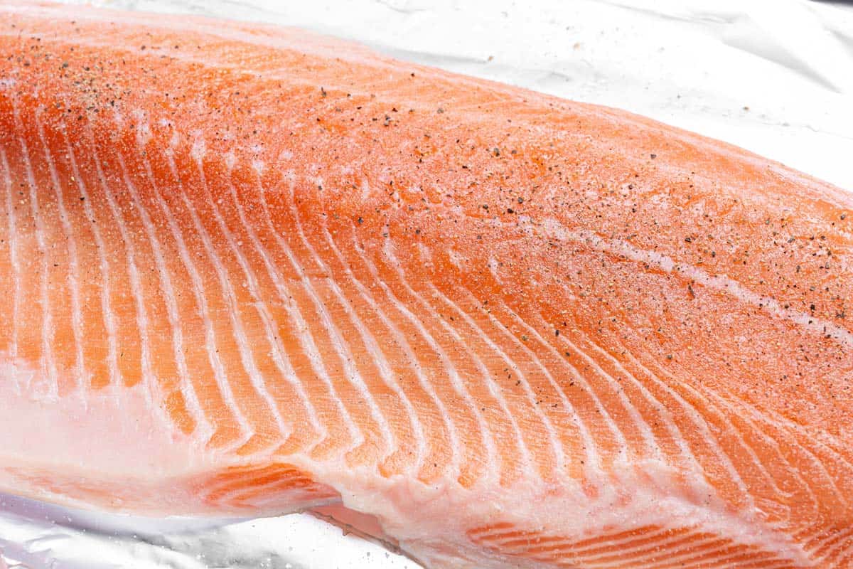 raw salmon seasoned with salt and pepper