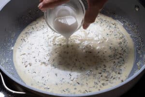 adding the cornstarch mixture to the center of the pan.