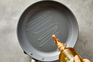 Oil drizzled into a large skillet before searing chicken