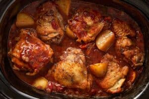 Slow cooker chicken cacciatore cooking with potatoes in tomato sauce