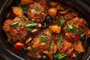 Slow cooker chicken cacciatore garnished with fresh parsley
